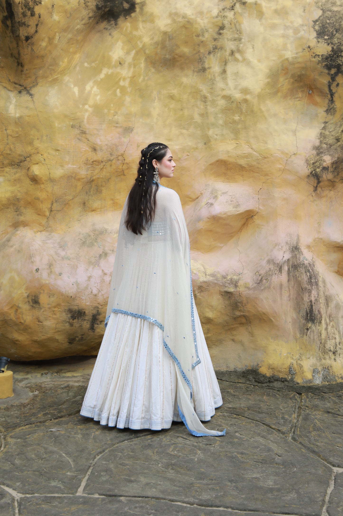 DEVI DRAPE IVORY MAL LEHANGA WITH DENIM HALTER NECK EMBELLISHED BLOUSE AND IVORY KOTA DORIA EMBELLISHED DUPATTA