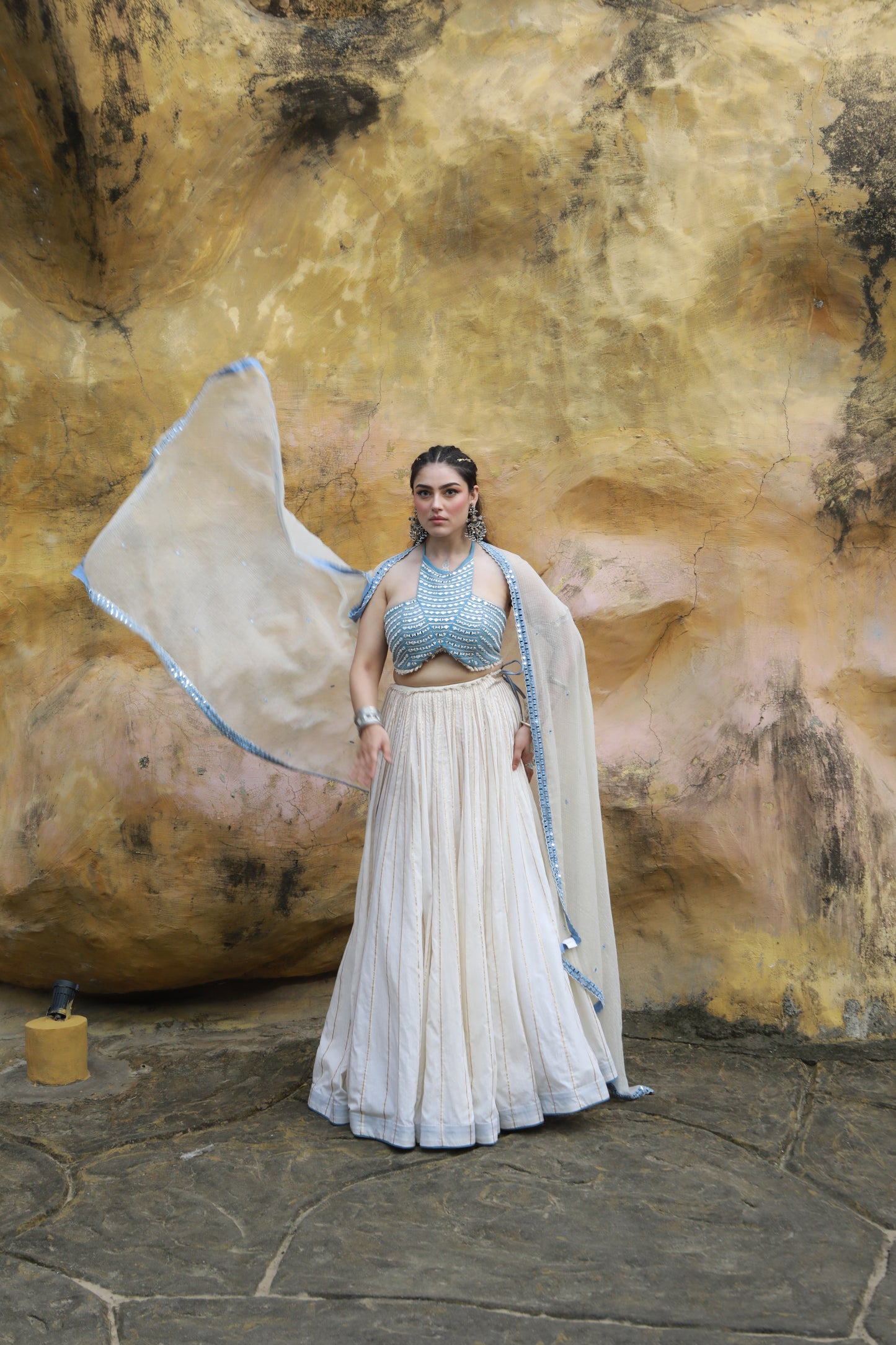 DEVI DRAPE IVORY MAL LEHANGA WITH DENIM HALTER NECK EMBELLISHED BLOUSE AND IVORY KOTA DORIA EMBELLISHED DUPATTA