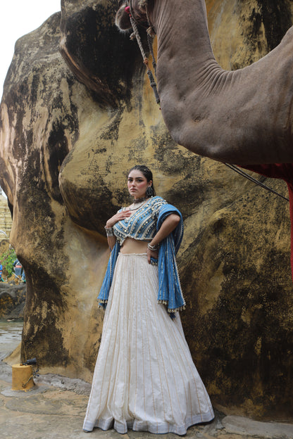 DEVI DRAPE IVORY MAL LEHANGA WITH DENIM LACE EMBELLISHED BLOUSE AND DENIM BLUE CRUSHED DUPATTA
