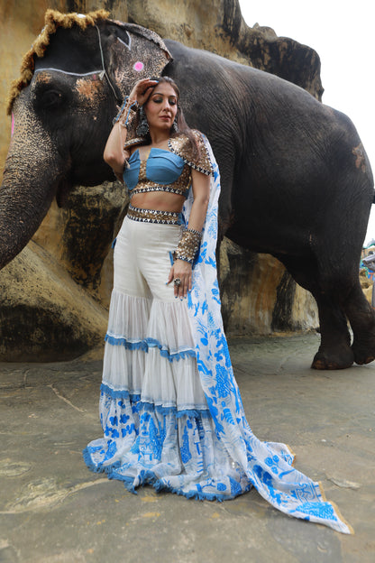 DEVI DRAPE IVORY KOTA DORIA HAND PAINTED SHARARA WITH DENIM EMBELLISHED BUSTIER & CAPE