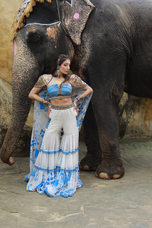 DEVI DRAPE IVORY KOTA DORIA HAND PAINTED SHARARA WITH DENIM EMBELLISHED BUSTIER & CAPE
