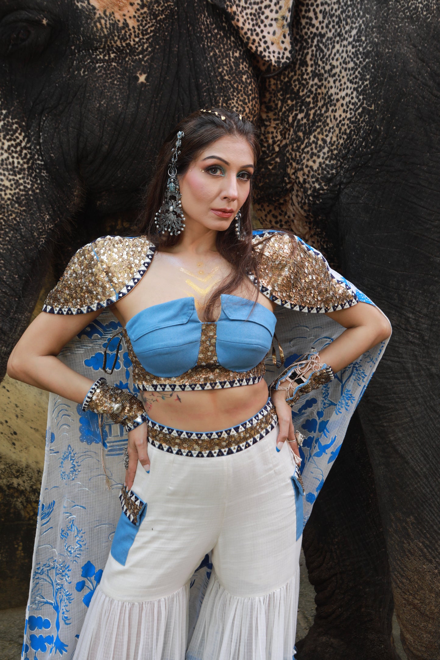DEVI DRAPE IVORY KOTA DORIA HAND PAINTED SHARARA WITH DENIM EMBELLISHED BUSTIER & CAPE