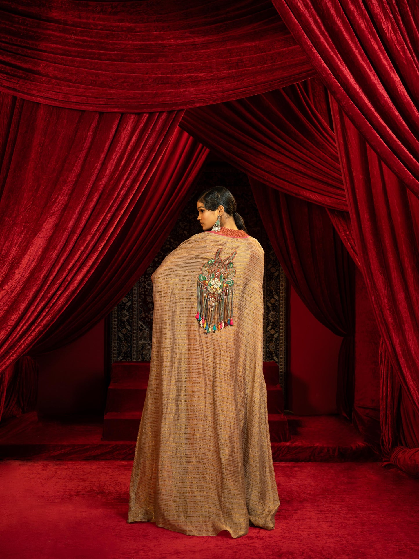 CRIMSON RED QUILTED BLOUSE WITH BOX PLEATED PANTS & SEPIA BROWN CAPE