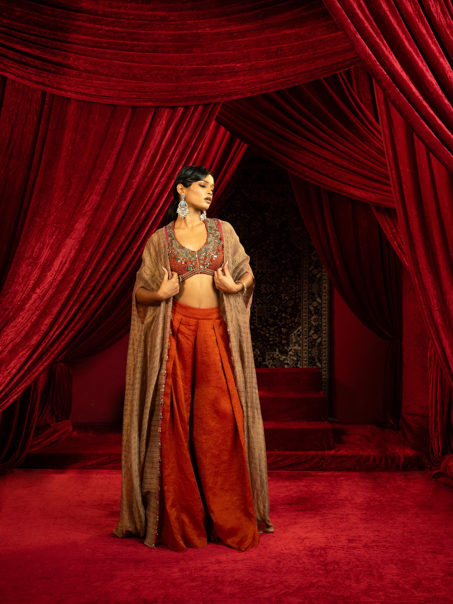 CRIMSON RED QUILTED BLOUSE WITH BOX PLEATED PANTS & SEPIA BROWN CAPE